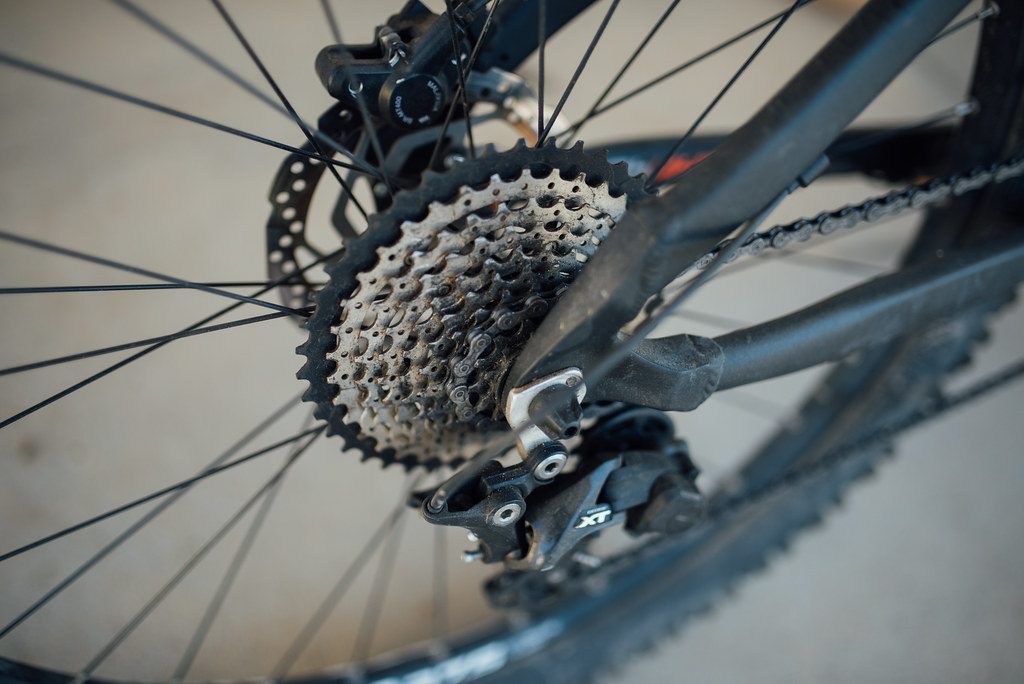This close-up features a mountain bike's gear system and rear derailleur