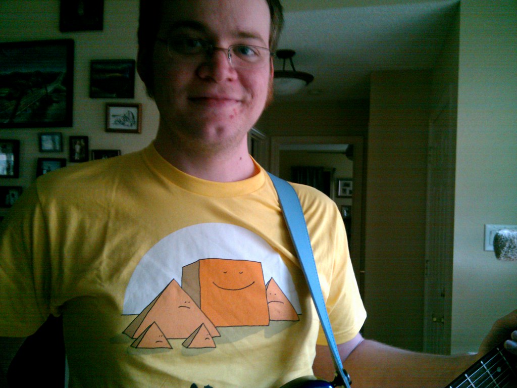 Two of my birthday presents: a T-shirt and a blue leather guitar strap
