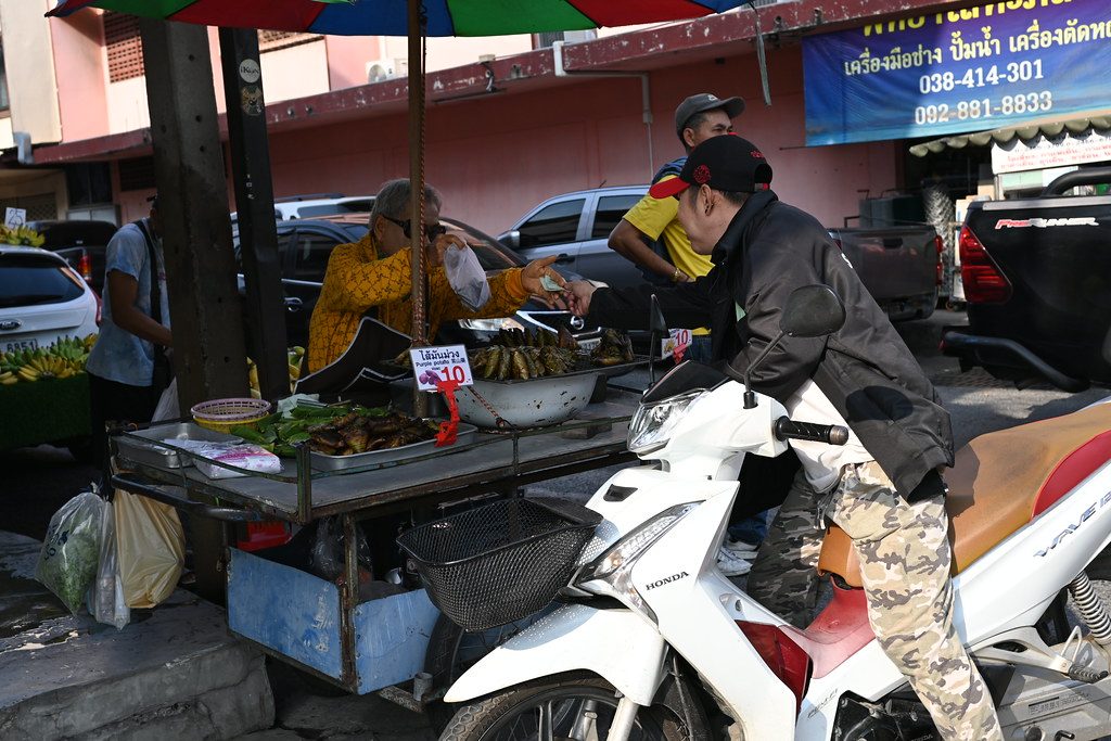 DSC_9743: a man standing next to a table with food on it