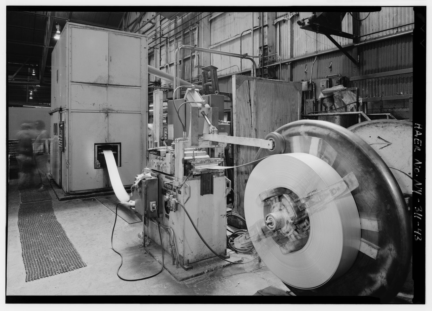 LOADING REEL AND PERFECTO STRIP STOCK FEEDER FOR -84 WATERBURY-FARREL (U.S. GOVERNMENT) PRESS. THIS CONTINUOUS-FEED, 2-DRAW, 100 TON PRESS IS ONE OF TWO IN THE U.S. UNDER CONTRACT HAER NY,15-BUF,25-43