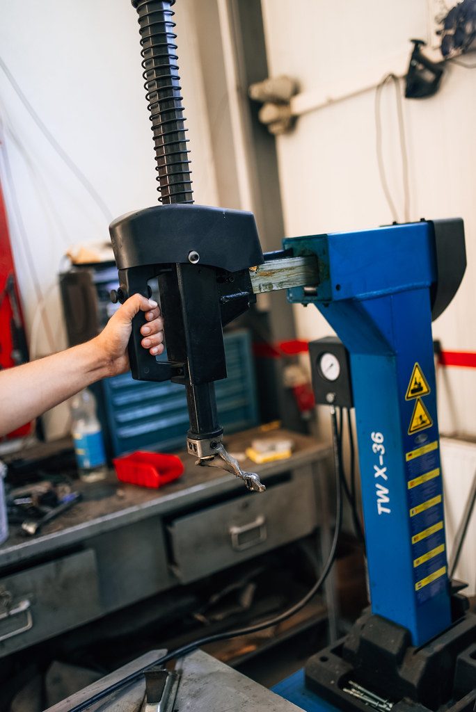 Mechanic operating a tire changer in his workshop