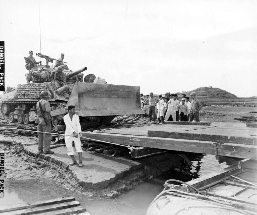 SC 349064 - An M4 heavy tank with bulldozer blade of the 1st Marine Div. is loaded on pontoon barge to be transported across Han River, during offensive launched by U.N. forces against the North Korean enemy troops in that area.