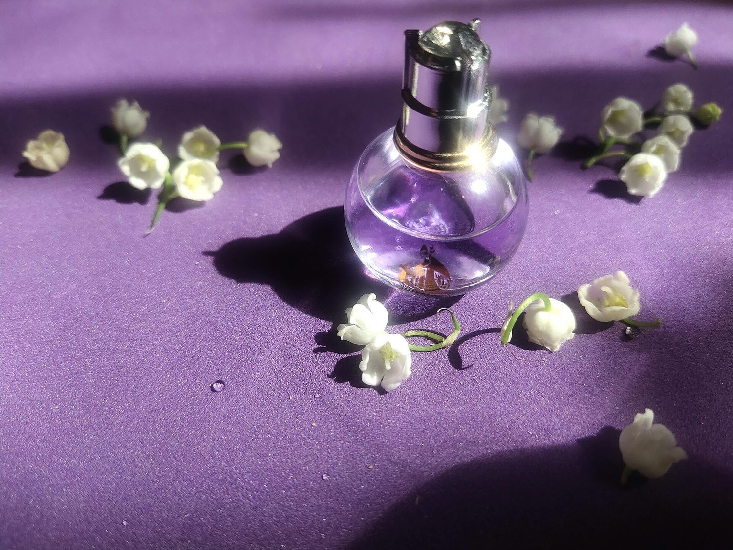 Elegant Perfume Bottle with Lily of the Valley Flowers