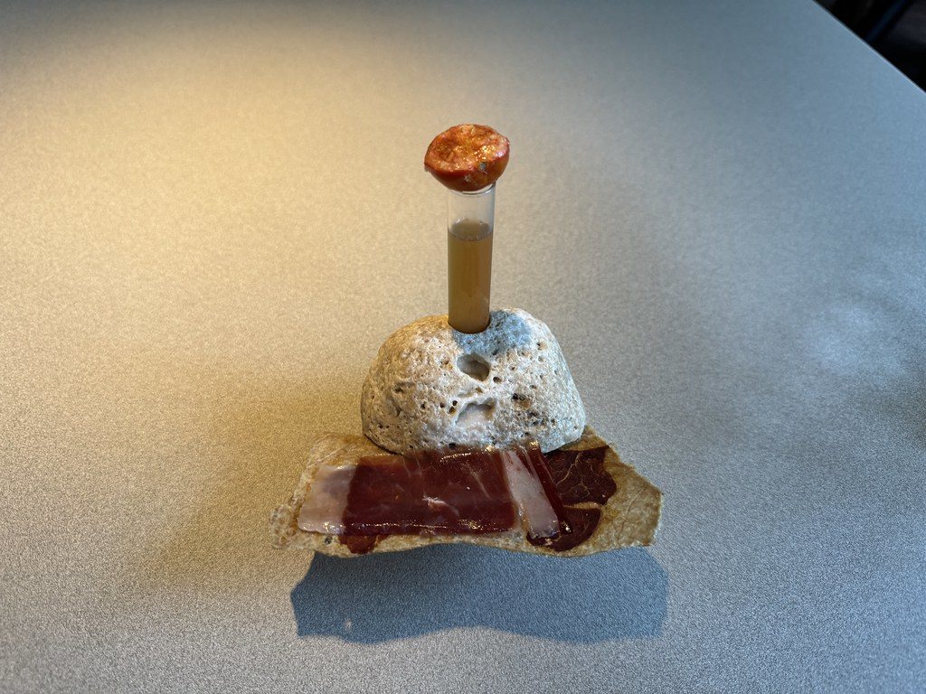 Fine Cut of Iberian pork belly 'torrezno' with Iberian Ham and tomatoes, dashed with olive oil