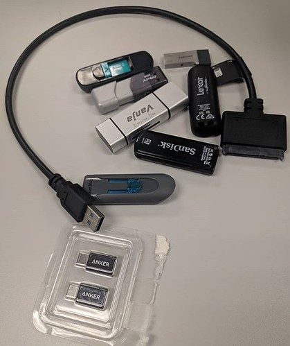 6 usb drives, 1 memory card adapter, one sata adapter, 2 micro to mini adapters. This is just some of the kit I have to keep with me for every day work. Starting to think I need a separate bag or wallet or something for all of this