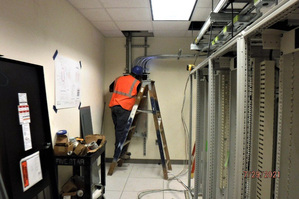 Layout and installation of Uninterruptible Power Supply (UPS) panel and their corresponding power feed conduits in an equipment room. 07-29-21