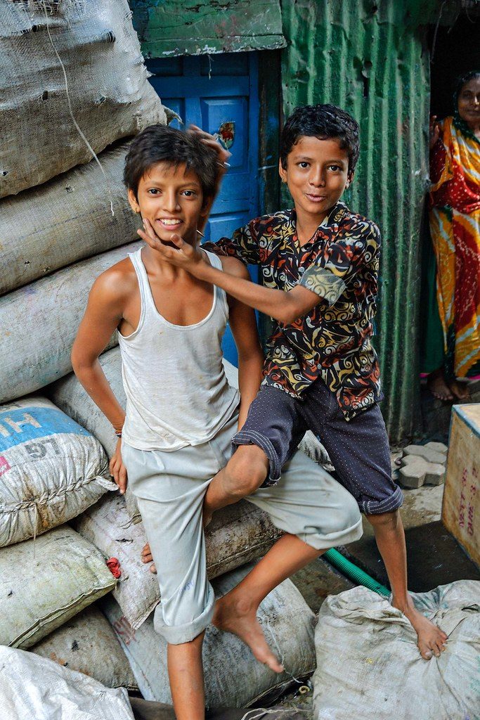 two-boys-frolicking-on-a-pile-of-plastic-bags-dharavi-india