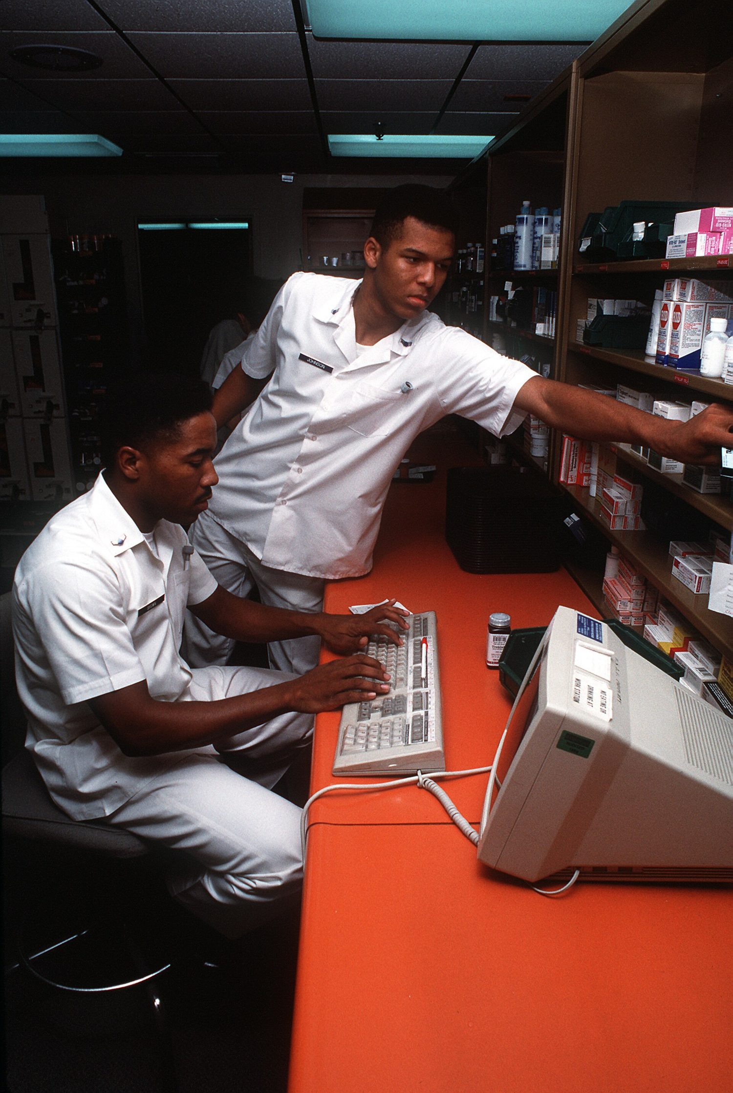 Airman first Class (A1C) George Brown, left, and A1C Kevin Johnson, pharmacy technicians, fill prescriptions using the Composite Health Care System (CHCS), a computer network that links various medical F-3006-SPT-93-000001-XX-0049