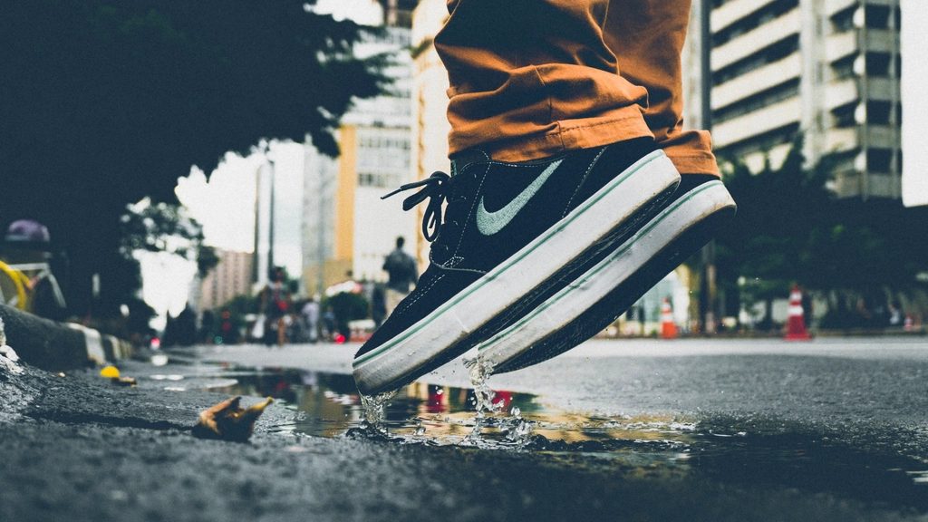 Nike sneakers, man jumping puddle
