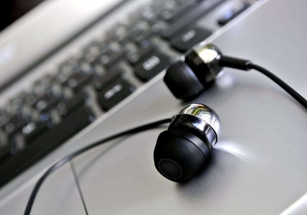 Wired Earphones on a Laptop Trackpad